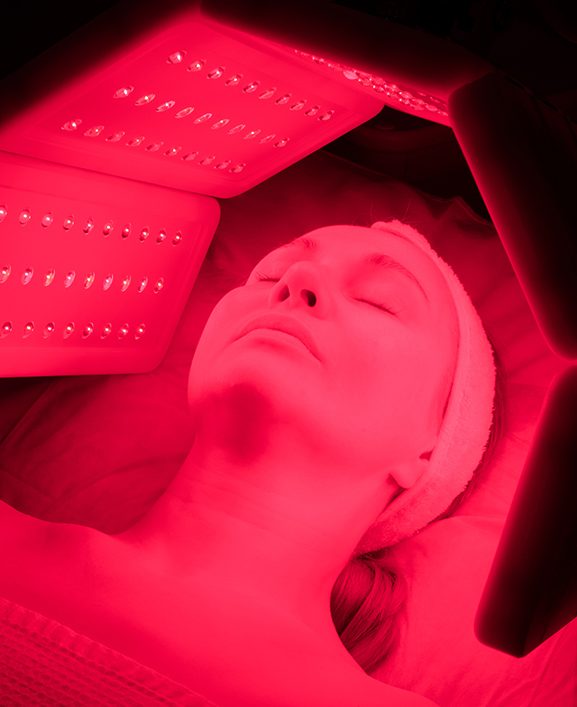 Woman receiving red light therapy treatments